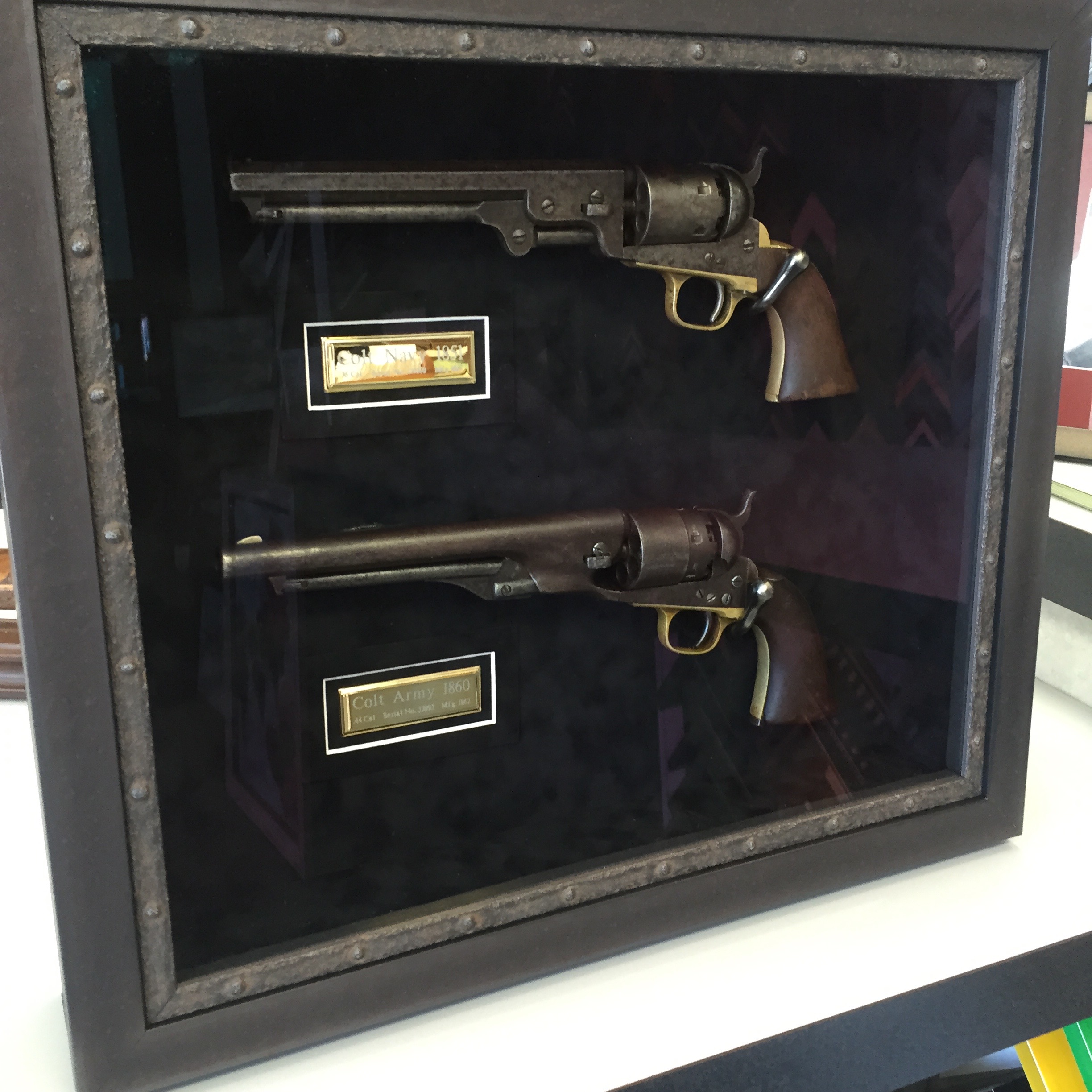 Custom framed shadow box of antique pistols